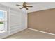 Bright bedroom with a large window and floor-to-ceiling built-in shelving, great for storage or decor at 5078 Florentine Ct, Spring Hill, FL 34608