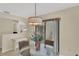 Eat-in kitchen area with glass table and view of lanai and backyard at 5078 Florentine Ct, Spring Hill, FL 34608