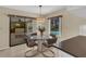 Eat-in kitchen area with glass table and view of lanai, pool, and backyard at 5078 Florentine Ct, Spring Hill, FL 34608