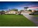 Charming single-story home with stone accents, well-manicured lawn, and an attached two-car garage at 5078 Florentine Ct, Spring Hill, FL 34608