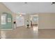 Open foyer featuring neutral tile flooring, arched entryways, and a view of other rooms in the home at 5078 Florentine Ct, Spring Hill, FL 34608
