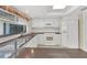 Bright kitchen with white appliances, granite countertop, and tile floors at 5078 Florentine Ct, Spring Hill, FL 34608