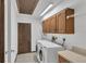 Functional laundry room with washer, dryer, cabinetry, and backyard access door for added convenience at 5078 Florentine Ct, Spring Hill, FL 34608