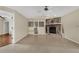 Bright living room featuring a stone fireplace, built-in shelving, and neutral tile flooring at 5078 Florentine Ct, Spring Hill, FL 34608