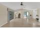 Spacious living room with tile flooring, sliding glass doors, and views into the dining and entry areas at 5078 Florentine Ct, Spring Hill, FL 34608