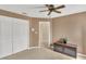 Neutral living room featuring tiled floors, a ceiling fan, and a built-in closet for ample storage at 5078 Florentine Ct, Spring Hill, FL 34608