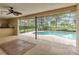Covered outdoor patio leading to a screened-in pool, ideal for relaxation and entertaining at 5078 Florentine Ct, Spring Hill, FL 34608