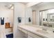 Bright bathroom featuring vanity, mirror, and tiled floors at 5084 Barrington Cir # 3202, Sarasota, FL 34234