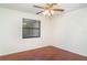Simple bedroom with wood-look floors, a ceiling fan, and natural light at 5084 Barrington Cir # 3202, Sarasota, FL 34234