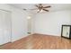 Spacious bedroom with wood flooring, a ceiling fan, a closet and an ensuite bathroom at 5084 Barrington Cir # 3202, Sarasota, FL 34234