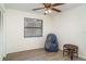 Comfortable bedroom features a ceiling fan, wood-look floors, natural light and a sitting area at 5084 Barrington Cir # 3202, Sarasota, FL 34234