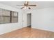 Bedroom with wood-look flooring, natural light, and access to ensuite bathroom at 5084 Barrington Cir # 3202, Sarasota, FL 34234
