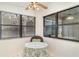Cozy breakfast nook featuring a round table, ceiling fan, and two large windows for natural light at 5084 Barrington Cir # 3202, Sarasota, FL 34234
