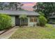 Charming single-story home with a well-maintained lawn, lush landscaping, and security door at 5084 Barrington Cir # 3202, Sarasota, FL 34234