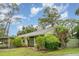 Exterior view of the single-story home with covered parking, well-kept lawns, and shrubbery at 5084 Barrington Cir # 3202, Sarasota, FL 34234