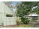 Charming home exterior with lush landscaping and a cozy, fenced yard at 5084 Barrington Cir # 3202, Sarasota, FL 34234