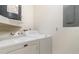 Laundry area featuring a washer, dryer, utility sink, and storage space at 5084 Barrington Cir # 3202, Sarasota, FL 34234