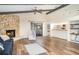 Bright living room features a stone fireplace, beamed ceilings, and wood-look flooring at 5084 Barrington Cir # 3202, Sarasota, FL 34234
