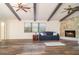 Open living area with beautiful wood floors, a stone fireplace, and two modern ceiling fans at 5084 Barrington Cir # 3202, Sarasota, FL 34234