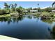 Relaxing view of a serene pond with a fountain and surrounding landscaping and homes at 5084 Barrington Cir # 3202, Sarasota, FL 34234