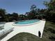 Inviting community pool with a sun deck, lounge chairs, and a tranquil shaded area at 5084 Barrington Cir # 3202, Sarasota, FL 34234