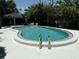 Private community swimming pool with clean, clear water, surrounded by a spacious deck at 5084 Barrington Cir # 3202, Sarasota, FL 34234