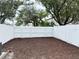 Backyard with new mulch and a new white fence, perfect for outdoor activities and enjoyment at 5229 Tennis Court Circle, Tampa, FL 33617