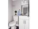 Updated half bathroom features a white vanity with granite countertops and modern fixtures at 5229 Tennis Court Circle, Tampa, FL 33617