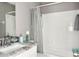 Bathroom with shower and tub combination and white vanity with granite countertop and modern fixtures at 5229 Tennis Court Circle, Tampa, FL 33617