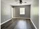 Bedroom with gray walls, new flooring, window, and white trim offers a comfortable retreat at 5229 Tennis Court Circle, Tampa, FL 33617