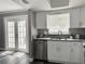 Well-lit kitchen with updated cabinets and granite countertops, flowing to back patio at 5229 Tennis Court Circle, Tampa, FL 33617
