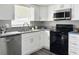 Modern kitchen featuring granite countertops, stainless steel appliances, and white cabinets at 5229 Tennis Court Circle, Tampa, FL 33617