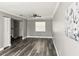 Comfortable living space featuring gray wood floors, ceiling fan, and natural light at 5229 Tennis Court Circle, Tampa, FL 33617