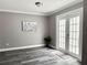 Bright living area with hardwood flooring, patio access, and decorative wall art at 5229 Tennis Court Circle, Tampa, FL 33617
