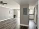 Bright living room with modern gray wood floors flowing to a galley kitchen and patio doors at 5229 Tennis Court Circle, Tampa, FL 33617