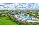 Aerial view of the community pool and clubhouse surrounded by lush landscaping and well-maintained homes at 5432 Rainwood Meadows Dr, Apollo Beach, FL 33572