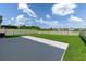 Spacious fenced-in backyard featuring a lush lawn and a concrete patio perfect for entertaining at 5432 Rainwood Meadows Dr, Apollo Beach, FL 33572