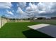 Large backyard with well-maintained lawn, fenced perimeter, and concrete patio, ideal for outdoor enjoyment at 5432 Rainwood Meadows Dr, Apollo Beach, FL 33572