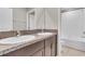 Bathroom with double sink vanity, granite countertop, and tub shower combination, perfect for families at 5432 Rainwood Meadows Dr, Apollo Beach, FL 33572