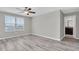 Neutral bedroom with a window and wood floors, with ensuite bathroom at 5432 Rainwood Meadows Dr, Apollo Beach, FL 33572