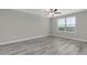Neutral bedroom with a window and wood floors at 5432 Rainwood Meadows Dr, Apollo Beach, FL 33572