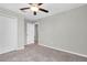 Neutral bedroom with modern fan and carpet, featuring large closet at 5432 Rainwood Meadows Dr, Apollo Beach, FL 33572