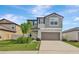 Charming two-story home with a well-manicured lawn and attached two-car garage at 5432 Rainwood Meadows Dr, Apollo Beach, FL 33572