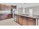 Modern kitchen with dark wood cabinets, granite countertops, stainless steel appliances, and tile flooring at 5432 Rainwood Meadows Dr, Apollo Beach, FL 33572