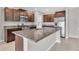 Spacious kitchen with stainless steel appliances, dark wood cabinetry, and a large island at 5432 Rainwood Meadows Dr, Apollo Beach, FL 33572