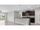 Open-concept kitchen features a breakfast bar, stainless steel appliances, and granite countertops at 5432 Rainwood Meadows Dr, Apollo Beach, FL 33572