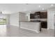 Open-concept kitchen features a breakfast bar, stainless steel appliances, and granite countertops at 5432 Rainwood Meadows Dr, Apollo Beach, FL 33572