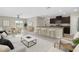 Open-concept living space featuring modern furnishings and a stylish kitchen with bar seating at 5432 Rainwood Meadows Dr, Apollo Beach, FL 33572
