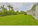 Lush backyard is beautifully landscaped with mature trees and a well-maintained lawn at 5511 Del Coronado Dr, Apollo Beach, FL 33572
