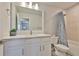 Bright bathroom with quartz countertops, modern vanity, large mirror, and stylish shower-tub combination at 5511 Del Coronado Dr, Apollo Beach, FL 33572